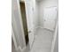 Hallway features a view into the closet with ample shelving and tile floors at 13014 Willow Grove Dr, Riverview, FL 33579