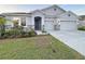 Charming single-Gathering home with a three-car garage, stone accents and tidy landscaping at 13014 Willow Grove Dr, Riverview, FL 33579