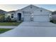 Charming single-Gathering home with a three-car garage and well-maintained landscaping at 13014 Willow Grove Dr, Riverview, FL 33579