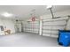 Bright two-car garage with grey painted floors and automatic garage door openers at 13014 Willow Grove Dr, Riverview, FL 33579