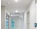 Bright hallway showcasing lake view, modern lighting, and neutral wall paint at 13014 Willow Grove Dr, Riverview, FL 33579