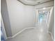 A long and bright hallway that connects the rooms, and has tiled floors at 13014 Willow Grove Dr, Riverview, FL 33579