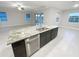 Modern kitchen with granite countertops, stainless steel appliances, and an open view to the living area at 13014 Willow Grove Dr, Riverview, FL 33579