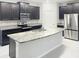 Modern kitchen with granite countertops, stainless steel appliances, and dark wood cabinets at 13014 Willow Grove Dr, Riverview, FL 33579