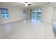 Bright living room featuring tile floors, recessed lighting, large sliding glass doors, and views of the lake at 13014 Willow Grove Dr, Riverview, FL 33579