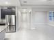 Open-concept living space features modern tile floors, recessed lighting and stainless steel kitchen appliances at 13014 Willow Grove Dr, Riverview, FL 33579