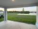 Covered patio overlooking a serene lake and lush lawn, perfect for outdoor relaxation at 13014 Willow Grove Dr, Riverview, FL 33579