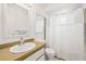 Clean bathroom featuring a white vanity and shower with curtain at 1410 Brighton Ct, Palm Harbor, FL 34684