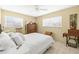 Bright bedroom with white bedding, dressers, and vintage sewing machine at 1410 Brighton Ct, Palm Harbor, FL 34684
