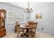 Cozy dining area with a round table, chandelier, and natural light at 1410 Brighton Ct, Palm Harbor, FL 34684