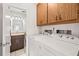 Laundry room with washer, dryer, and convenient access to the bathroom at 1410 Brighton Ct, Palm Harbor, FL 34684
