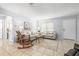 Open living room featuring tile floors, neutral tones, and rocking chair at 1410 Brighton Ct, Palm Harbor, FL 34684