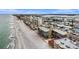 Aerial view of condo building, beach and ocean in an attractive coastal setting at 14900 Gulf Blvd # 308, Madeira Beach, FL 33708