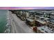 Aerial view of condo building, beach and ocean in an attractive coastal setting at 14900 Gulf Blvd # 308, Madeira Beach, FL 33708