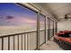 Inviting balcony with comfortable seating offering panoramic ocean views and beach access at sunset at 14900 Gulf Blvd # 308, Madeira Beach, FL 33708