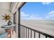 Cozy balcony featuring a sun decoration, a table with chairs, and stunning ocean views at 14900 Gulf Blvd # 308, Madeira Beach, FL 33708