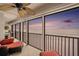 Enjoy ocean views from this inviting balcony with comfortable seating and a ceiling fan at sunset at 14900 Gulf Blvd # 308, Madeira Beach, FL 33708