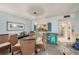 Dining area with wicker dining set and access to the kitchen with breakfast bar seating at 14900 Gulf Blvd # 308, Madeira Beach, FL 33708