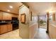 Condo hallway with tile flooring leads to entry door and the kitchen at 14900 Gulf Blvd # 308, Madeira Beach, FL 33708