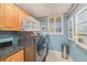 Convenient laundry area featuring cabinets, modern washer and dryer set, and lots of light at 14900 Gulf Blvd # 308, Madeira Beach, FL 33708