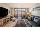 Comfortable living room with tile floors and sliding glass doors to a balcony with ocean view at 14900 Gulf Blvd # 308, Madeira Beach, FL 33708