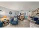 Comfortable living room featuring tile floors, wicker chairs, blue furnishings, and a view into the kitchen at 14900 Gulf Blvd # 308, Madeira Beach, FL 33708