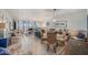 Spacious living room area with tile floors, wicker dining set, comfortable sofas, and ocean views at 14900 Gulf Blvd # 308, Madeira Beach, FL 33708