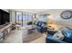 Living room with tile floors and sliding glass doors to a balcony with ocean view at 14900 Gulf Blvd # 308, Madeira Beach, FL 33708