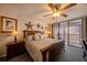 Comfortable main bedroom with a ceiling fan, ocean views and a large bed and matching dressers at sunset at 14900 Gulf Blvd # 308, Madeira Beach, FL 33708