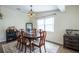 Comfortable dining room with a stylish rug, dark wood floors, and neutral paint at 1512 56Th N Ave, St Petersburg, FL 33703