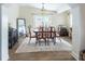 Comfortable dining room with a stylish rug, dark wood floors, and neutral paint at 1512 56Th N Ave, St Petersburg, FL 33703