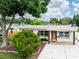 Charming single-story home with well-maintained landscaping, decorative shutters, and a covered front entry at 1512 56Th N Ave, St Petersburg, FL 33703