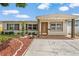 Well-maintained single-story home with mature landscaping and a covered front porch at 1512 56Th N Ave, St Petersburg, FL 33703