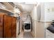 A small utility room featuring a washer, dryer, shelving units and wood accents at 1512 56Th N Ave, St Petersburg, FL 33703
