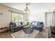 Bright living room featuring a comfortable L-shaped sofa, decorative pillows, and natural light at 1512 56Th N Ave, St Petersburg, FL 33703