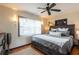 Cozy main bedroom with a wooden frame bed, neutral colors, and ample natural light at 1512 56Th N Ave, St Petersburg, FL 33703