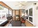 Enclosed patio featuring tile floors, a ceiling fan, and an outdoor dining area at 1512 56Th N Ave, St Petersburg, FL 33703