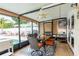 A comfortable covered patio with dining table, exterior lights, and fan with direct access to the pool at 1512 56Th N Ave, St Petersburg, FL 33703