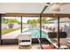 Enclosed patio offers an outside view of a private pool, grill and white privacy fence at 1512 56Th N Ave, St Petersburg, FL 33703