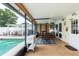 A comfortable covered patio with dining table, exterior lights, and fan with direct access to the pool at 1512 56Th N Ave, St Petersburg, FL 33703