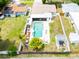 Aerial view of a private pool area with a patio, lounge chairs, and well-maintained landscaping at 1512 56Th N Ave, St Petersburg, FL 33703