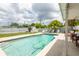 Backyard pool features lounge seating, privacy fence, and tropical landscaping for a relaxing outdoor space at 1512 56Th N Ave, St Petersburg, FL 33703
