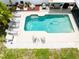 Aerial view of a private pool area with patio furniture and tropical landscaping at 1512 56Th N Ave, St Petersburg, FL 33703