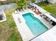 Aerial view of a backyard pool area with lounge chairs and a well-manicured yard at 1512 56Th N Ave, St Petersburg, FL 33703