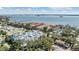 Stunning aerial showcases the community with serene waterfront, luxurious residences, lush greenery, and convenient parking at 1515 Bayshore Blvd # 38, Dunedin, FL 34698