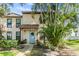 Charming two-story home with a light blue door and well-maintained landscaping at 1515 Bayshore Blvd # 38, Dunedin, FL 34698