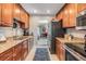 Kitchen area with wooden cabinets and stainless steel appliances at 1515 Bayshore Blvd # 38, Dunedin, FL 34698