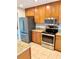 An updated kitchen featuring stainless steel appliances, granite countertops, and wood cabinets at 1515 Bayshore Blvd # 38, Dunedin, FL 34698
