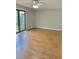 Bright living room featuring wood floors, a ceiling fan, and large sliding glass doors at 1515 Bayshore Blvd # 38, Dunedin, FL 34698