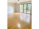 Light-filled living room showcasing wood floors, neutral walls, and sliding glass doors at 1515 Bayshore Blvd # 38, Dunedin, FL 34698